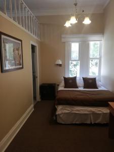 a bedroom with a large bed and a window at Belle Epoque Hostal in Viña del Mar