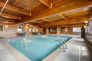 a swimming pool in a house with a wooden ceiling at Best Western Pinedale Inn in Pinedale