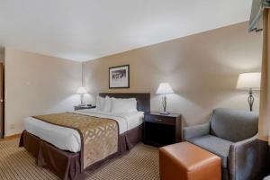 a hotel room with a bed and a chair at Best Western Pinedale Inn in Pinedale +23 photos