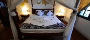 a bedroom with a bed with flowers on it at Kenyan House Malindi in Malindi
