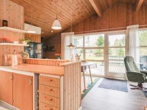 a kitchen with a counter and a table and chairs at 5 person holiday home in Jerup-By Traum in Jerup