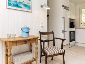 een keuken met een houten tafel en een stoel bij 6 person holiday home in Bindslev in Bindslev