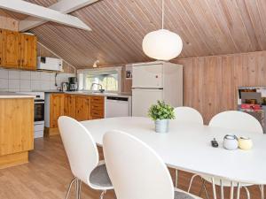 エーベルトフトにある6 person holiday home in Ebeltoftのキッチン(白いテーブル、椅子付)