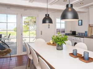 a kitchen with a large white table and chairs at Three-Bedroom Holiday home in Hemmet 90 in Falen