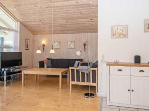 a living room with a table and a couch at 6 person holiday home in Hemmet in Hemmet