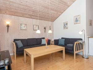 a living room with a couch and a table at 6 person holiday home in Hemmet in Hemmet