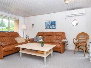 a living room with a couch and a coffee table at 6 person holiday home in Hemmet in Falen