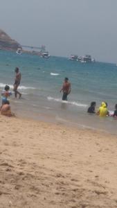 a group of people playing in the water at the beach at Villa Oussama porto families only in Ain Sokhna