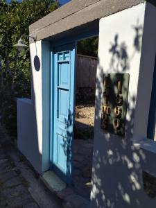 a blue door on the side of a house at Latmos 1860 in Skala