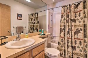 a bathroom with a sink and a toilet and a shower curtain at Deck and Resort Amenities Pocono Lake Home in Pocono Lake +28 photos