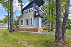 a tiny house with a deck and a balcony at Modern Starkville Tiny Home Near Dining and MSU in Starkville