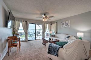 a living room with a couch and a table at Osage Beach Condo with Pool Access and Lake Views in Osage Beach