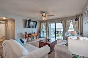 a living room with two couches and a table at Osage Beach Condo with Pool Access and Lake Views in Osage Beach
