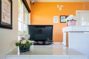 a desk with a computer monitor on top of it at Solaire Inn & Suites in Santa Maria