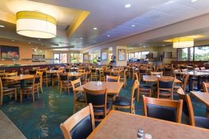 a dining room with tables and chairs at Rosen Inn Lake Buena Vista in Orlando
