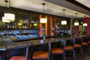 a bar in a restaurant with chairs and a counter at Rosen Inn Lake Buena Vista in Orlando