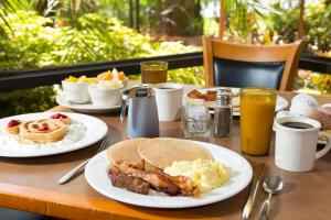 a table with plates of breakfast food on it at Rosen Inn Lake Buena Vista in Orlando