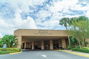 a building with a parking lot in front of it at Rosen Inn Lake Buena Vista in Orlando