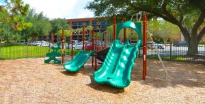 a playground with three slides in a park at Rosen Inn Lake Buena Vista in Orlando