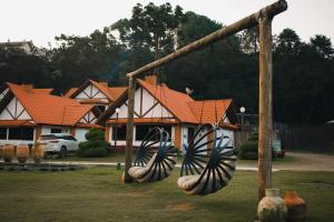 a playground in front of a house with houses at Pousada Röhsler in Monte Verde