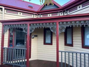 a front porch of a house with a red roof at BENDIGO BOTANIC MOTEL- with KING BEDS-REFURBISHED 2022 in Bendigo