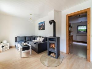 a living room with a couch and a fireplace at Peaceful Bungalow, Güntersberge in Harzgerode