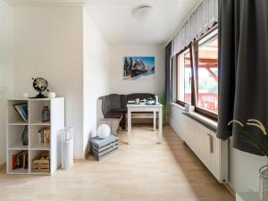 a living room with a table and a chair at Peaceful Bungalow, Güntersberge in Harzgerode