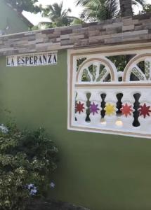 a sign on the side of a house with a window at Villa La Esperanza 