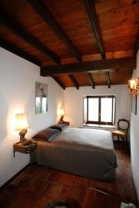 a bedroom with a large bed with two lamps on it at B&B Castel Ivano in Strigno