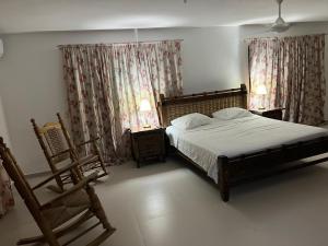 En eller flere senge i et værelse på Villa La Esperanza