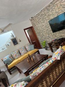 a living room with a couch and a table at Villa La Esperanza in Nizao