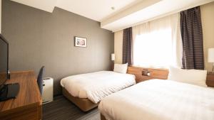 Postel nebo postele na pokoji v ubytování Via Inn Shinagawa Oimachi
