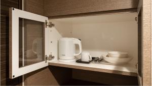 a kitchen with a coffee maker on a counter at Via Inn Higashiginza in Tokyo