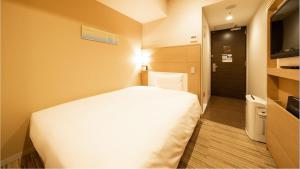 Postel nebo postele na pokoji v ubytování Via Inn Higashiginza