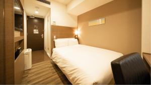 Postel nebo postele na pokoji v ubytování Via Inn Higashiginza