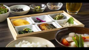a wooden box filled with different types of food at Via Inn Shinsaibashi in Osaka