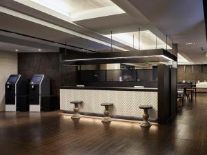 a kitchen with a bar with a counter with stools at Via Inn Shinsaibashi in Osaka