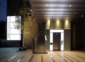 a stairway leading to a building with a door at Via Inn Shinsaibashi in Osaka