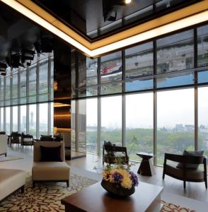 a lobby with large windows and a table and chairs at Via Inn Abeno Tennoji in Osaka