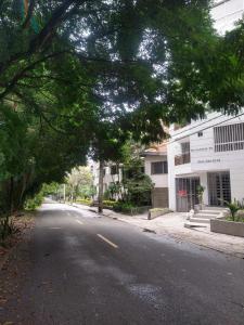 eine leere Straße mit Bäumen über der Straße in der Unterkunft Conquistadores Romantic, Medellín in Medellín
