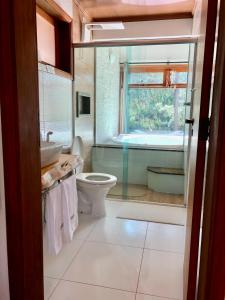 a bathroom with a toilet and a sink and a tub at Afha 48 in Monte Verde
