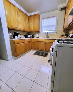 a kitchen with wooden cabinets and a stove top oven at Vintage Charm, E. Eng. Village, 10mins to Dt. Det. in Detroit