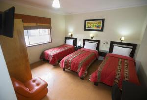 Postel nebo postele na pokoji v ubytování Hotel Tinkus Inn