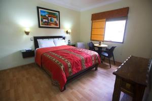 Postel nebo postele na pokoji v ubytování Hotel Tinkus Inn
