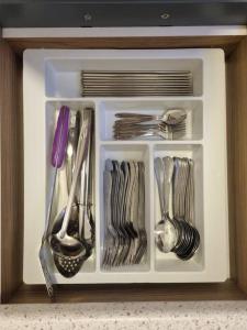 a white drawer filled with utensils in a cabinet at Modern 4BR Double Storey @ Setia Alam in Shah Alam