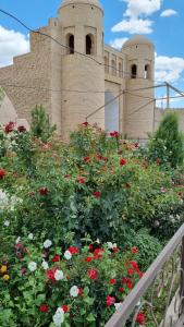a bunch of flowers in front of a building at Khiva Angarik Darvoza in Khiva