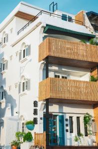 a building with wooden balconies on the side of it at Bethlehem B&B Kenting in Eluan