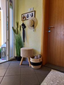 a room with a chair and an umbrella next to a door at Apartman ELLA in Peračko Blato