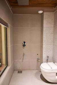 a bathroom with a shower with a toilet at Suvidha Suites in Vasai