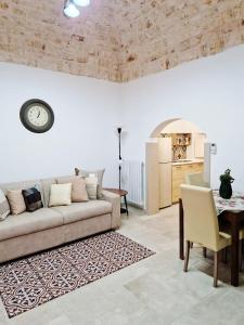 a living room with a couch and a table at Dimora Biancodoro in Locorotondo